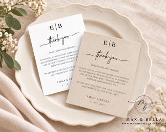 May include: Two rectangular wedding thank you cards, one white and one light tan, featuring the monogram EB, the word thank you in script, and printed text addressed to family and friends from Emma and Bryan with the date 6.16.2027.