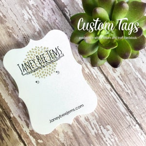 May include: White, cream, and kraft cardstock custom tags with the text "JANEY BEE JEMS handmade jewelry by Brooke Ballard" and the website address "Janeybeejems.com".