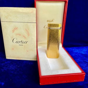 Encendedor Cartier Trinity Gold Vintage, excepcional, en perfecto estado, funciona con 1 año de garantía.
