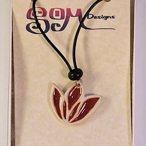 Lotus flower motif ceramic pendant necklace on leather cord