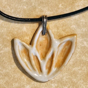 Lotus flower motif ceramic pendant necklace on leather cord