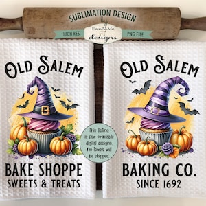 May include: Two white kitchen towels with a sublimation design featuring a purple and black witch hat on top of a cupcake with pumpkins and bats. The text on the towels reads "Old Salem Bake Shoppe Sweets & Treats" and "Old Salem Baking Co. Since 1692".