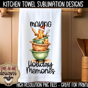 May include: White kitchen towel with a festive design featuring gingerbread people in mixing bowls. The towel reads "MAKING Holiday Memories" in black script. The design includes a gingerbread person wearing a Santa hat. The towel is hanging on a wooden rod.
