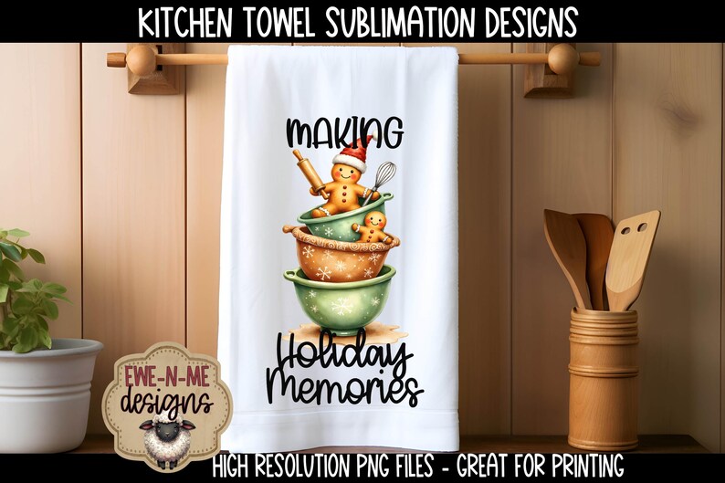 May include: White kitchen towel with a festive design featuring gingerbread people in mixing bowls. The towel reads "MAKING Holiday Memories" in black script. The design includes a gingerbread person wearing a Santa hat. The towel is hanging on a wooden rod.