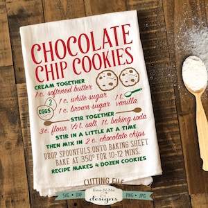 May include: A white tea towel with a green and red recipe for chocolate chip cookies. The recipe includes ingredients like butter, sugar, flour, and chocolate chips. The text reads "Chocolate Chip Cookies" and "Recipe Makes 4 Dozen Cookies".