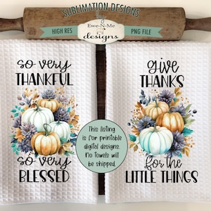May include: Two white kitchen towels with a Thanksgiving theme. The left towel features a bouquet of autumn flowers with pumpkins and the text "so very thankful so very blessed". The right towel features a similar bouquet with the text "give thanks for the little things".