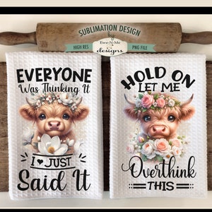 May include: Two white kitchen towels with a sublimation design featuring a Highland cow with flowers. The text on the towels reads "Everyone was thinking it I just said it" and "Hold on let me overthink this".