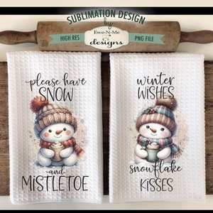May include: Two white kitchen towels with winter-themed designs. The first towel features a snowman holding a cup of hot chocolate with the text "please have snow and mistletoe". The second towel features a snowman holding a cup of hot chocolate with the text "winter wishes snowflake kisses".