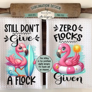 May include: Two white kitchen towels with sublimation designs. The left towel features a pink flamingo with a surfboard and the text "Still Don't Give A Flock". The right towel features a pink flamingo in a pink inflatable ring and the text "Zero Flocks Given".