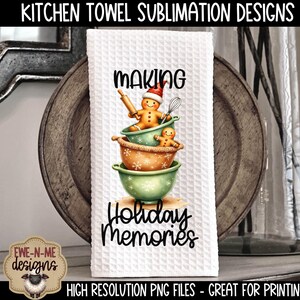 May include: White kitchen towel with a waffle weave texture. The towel features a design of gingerbread people in bowls with the words "MAKING Holiday Memories". The towel is displayed on a wooden plate.