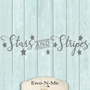 May include: A light blue wood background with the text "Stars and Stripes" in gray cursive lettering with stars around the text. Below the text is a white oval with a brown border and the text "Ewe-N-Me designs" in brown lettering.