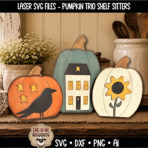 May include: A trio of decorative wooden pumpkin shelf sitters featuring laser-cut designs. One orange pumpkin displays a black crow and three yellow stars, a blue pumpkin features a white house with yellow windows, and a white pumpkin shows a sunflower.