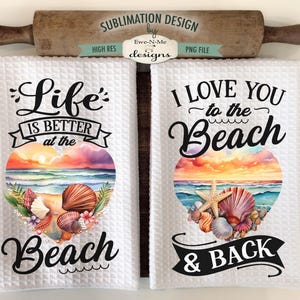 May include: Two white kitchen towels with a beach theme. The first towel says "Life is better at the beach" with a watercolor sunset and seashells. The second towel says "I love you to the beach & back" with a watercolor sunset and seashells.