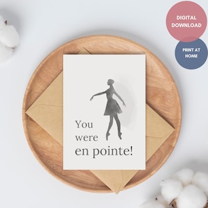 May include: A greeting card with a watercolor illustration of a ballerina in a tutu, with the text "You were en pointe!" The card is on a wooden plate with a kraft paper envelope. Two circular graphics read "DIGITAL DOWNLOAD" and "PRINT AT HOME."