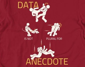 May include: Red t-shirt with a white graphic of stick figures fighting. The text "DATA IS NOT PLURAL FOR ANECDOTE" is written in yellow.