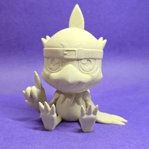 May include: A light beige figurine of a bird-like creature with large eyes, a head crest, and a belt-like band around its head. The figurine is sitting with one finger pointing up. The creature has a beak and clawed feet.