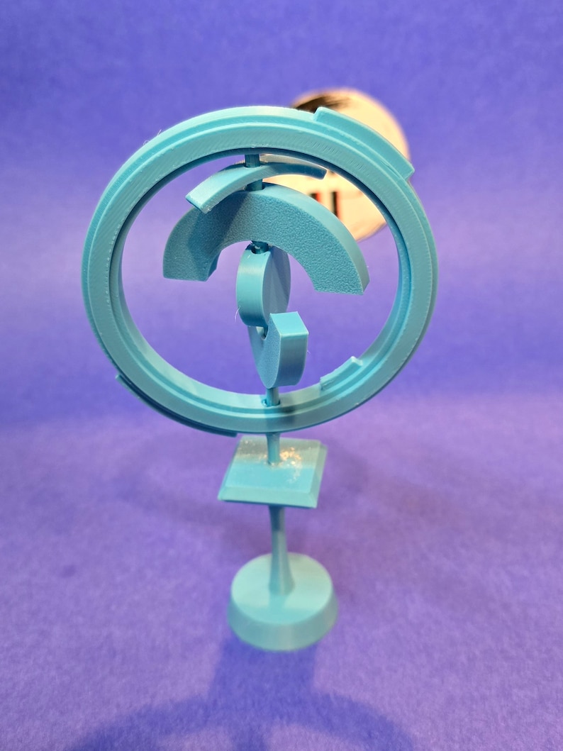 May include: A light blue 3D printed sculpture with a circular design and a square base. The sculpture is made of multiple interlocking pieces.