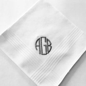 May include: White cotton handkerchief with a gray embroidered monogram of the letters "AGB" in a circle.