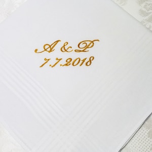 May include: White linen handkerchief with gold embroidery. The embroidery reads "A & P 7.7.2018".