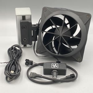 May include: A black computer cooling fan with a square frame and nine blades, attached to a silver metal mounting bracket. Included are a black USB power cable and a small black control box with a dial and a white fan icon on the front.