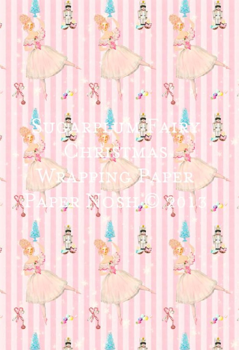 May include: Pink and white striped wrapping paper with a repeating pattern of ballerinas holding Christmas trees, nutcrackers, and candy canes. The text "Sugarplum Fairy Christmas Wrapping Paper Paper Nosh &copy; 2013" is printed on the paper.