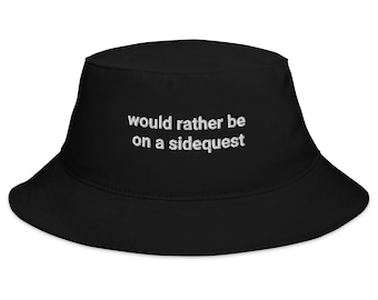 May include: Black bucket hat with the text "would rather be on a sidequest" embroidered in white.