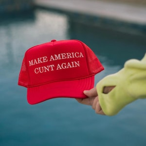 May include: Red mesh trucker hat with the text "MAKE AMERICA CUNT AGAIN" in white.