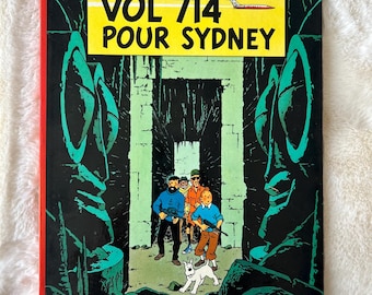 Les Aventures de Tintin: Vol 714 Pour Sydney autorstwa Hergé, pierwsze wydanie komiksu w twardej oprawie w języku francuskim, opublikowane w 1968 r. przez Casterman
