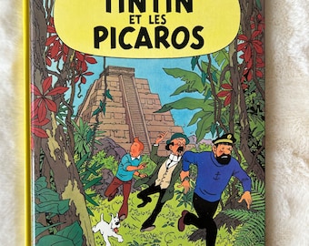 Les Aventures de Tintin: Tintin et les Picaros de Hergé, primeira edição de quadrinhos de capa dura em francês, publicada em 1976 por Casterman