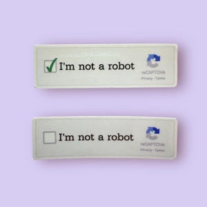 May include: Two rectangular stickers with the text "I'm not a robot." One has a green checkmark in a box, the other has an empty box. Both have the reCAPTCHA logo and text.