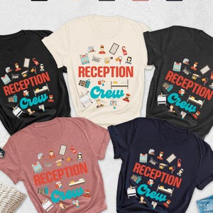 May include: A collection of short-sleeved t-shirts in various colors, including black, navy, and heather mauve, each featuring the text "RECEPTION Crew" in red and teal, along with related graphics. A straw hat, sunglasses, and jeans are also visible.