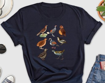 May include: A navy blue t-shirt with a graphic of various birds, including a quail, a pheasant, and a grouse.
