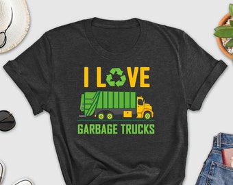 May include: A dark grey t-shirt with a green and yellow garbage truck graphic and the text "I LOVE GARBAGE TRUCKS".