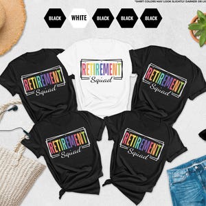 May include: A collection of black and white t-shirts with the text "RETIREMENT Squad" in a rainbow-colored font. The shirts are arranged on a light surface with a straw hat, sunglasses, and a pair of jeans.