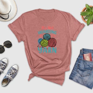 a women's t - shirt that says knitting is fun