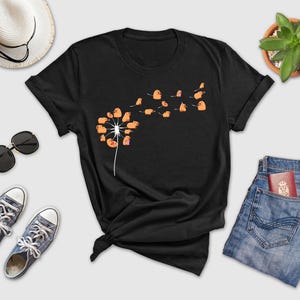 a t - shirt with a dandelion design on it