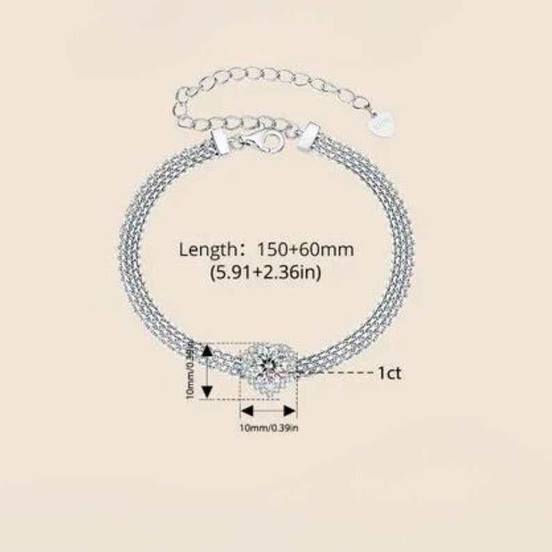 May include: Silver bracelet with a square-shaped cubic zirconia stone in the center. The bracelet is 5.91 inches long and has an adjustable extension chain. The stone is 1 carat.
