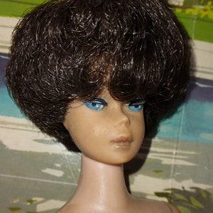 Bubble cut brunette Barbie, fuller face.