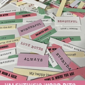 May include: Valentine's Word Bits set with 50 pieces. The image shows a collection of small, rectangular paper tags in various colors, including pink, green, and yellow. Each tag features a word or phrase related to love and Valentine's Day, such as "Always" and "Beautiful".