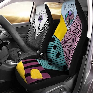 May include: Car seat covers featuring designs from "The Nightmare Before Christmas." One cover has a black and white striped pattern with a key and the text "Meant to be." The other has a patchwork design with the text "Simply."