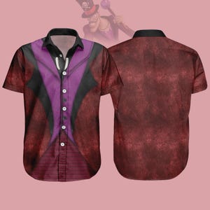 May include: Short-sleeved button-down shirt with a burgundy textured pattern. The front features a purple vest design with black accents and white buttons. A cartoon image of a character in a top hat is in the background.