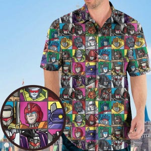 May include: Short-sleeved button-down shirt featuring a colorful grid pattern of robot character faces. The design includes a variety of colors, including red, blue, yellow, and green, creating a vibrant and eye-catching look. The shirt has a classic collar and a relaxed fit.