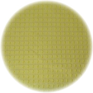 May include: A circular, light yellow object with a repeating pattern of small, stylized figures. The figures are arranged in horizontal rows and vertical columns. The object has a soft, textured appearance and is set against a white background.