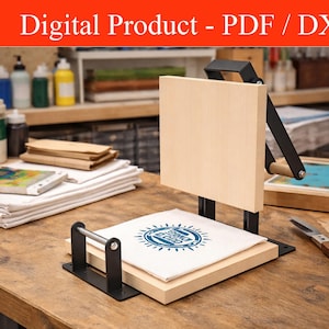 May include: A wooden printing press with a black metal frame and a light-colored wooden base. A white cloth with a blue circular design is placed on the base. The text "Digital Product - PDF / DXF" is at the top of the image.