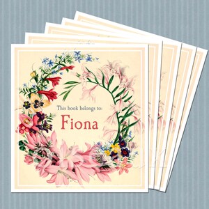 Vintage bookplates featuring a wreath of flowers against a cream background, text is in pale blue, name is in pink, with a slim white border around the edge. Flowers are pink, red, blue, purple or various sizes