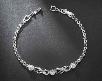 Pulsera infinita chapada en oro blanco con incrustaciones de circón de 8 palabras populares europeas y americanas