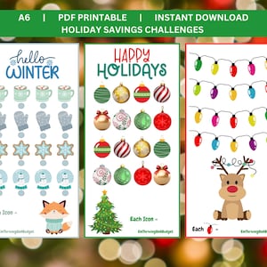 May include: Three printable holiday savings challenge cards. The first card features a winter theme with a mug of hot chocolate, mittens, snowflakes, and snowmen. The second card features a Christmas theme with ornaments, a Christmas tree, and the text "Happy Holidays". The third card features a reindeer and a string of Christmas lights.