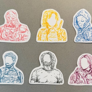 May include: Set of six die-cut stickers featuring stylized illustrations of characters in various colors. The stickers include red, yellow, blue, and black designs. The illustrations are of figures with detailed outlines and a minimalist style.