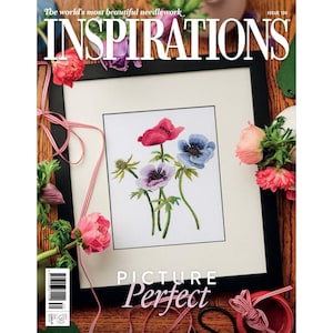Peut inclure: Une broderie encadrée de fleurs d'anémones colorées en rouge, bleu et violet. Le cadre noir entoure l'œuvre sur un passe-partout blanc. La couverture du magazine "Inspirations" est visible, avec le texte "Picture Perfect".