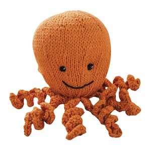 May include: A knitted orange octopus plush toy with a smiling face. The octopus has eight curly tentacles.